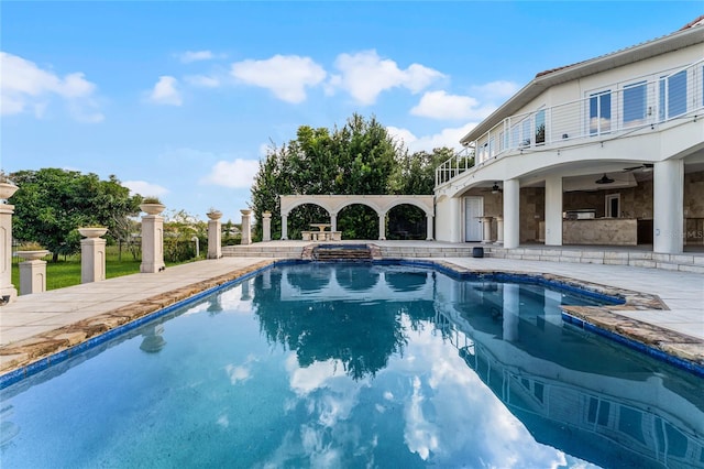 view of pool featuring ceiling fan and a patio area