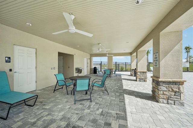 view of patio / terrace featuring outdoor dining area, ceiling fan, and fence