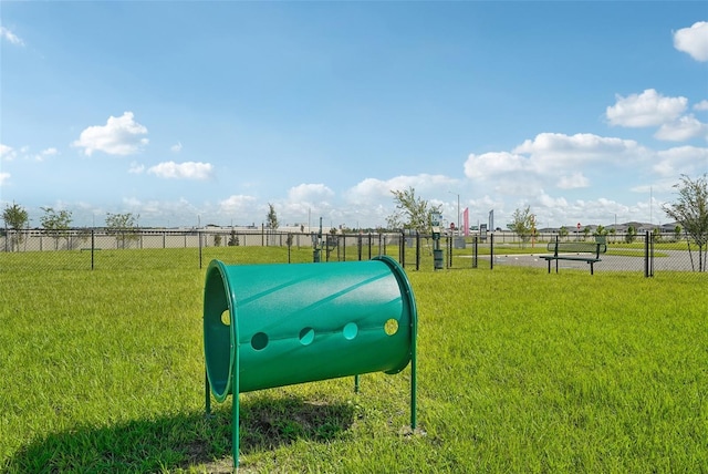 view of home's community with a yard and fence