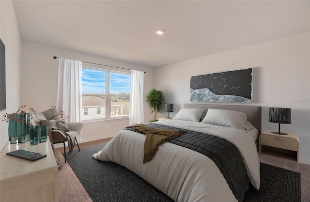 bedroom with a textured ceiling and carpet floors