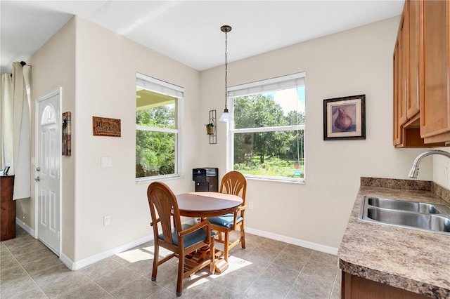 dining area with light tile patterned floors and baseboards