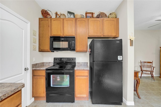 kitchen featuring black appliances, light tile patterned floors, light countertops, and baseboards