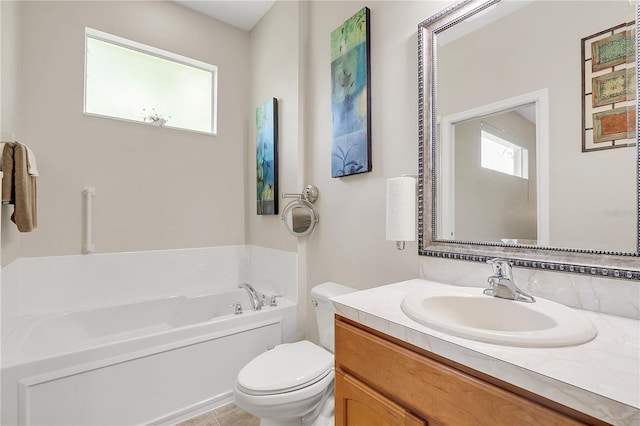 full bath featuring toilet, a garden tub, plenty of natural light, and vanity