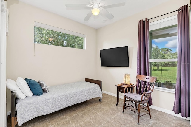 tiled bedroom featuring baseboards and ceiling fan