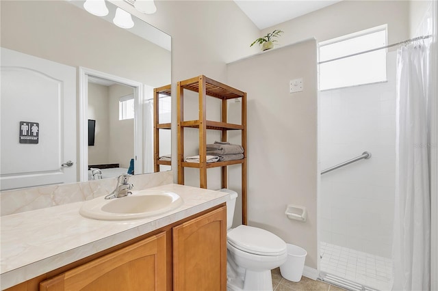 full bath featuring tile patterned flooring, toilet, vanity, and a tile shower