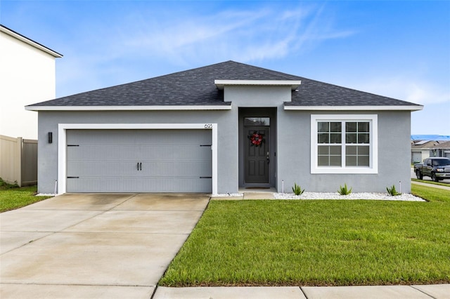 view of front facade with a front lawn and a garage