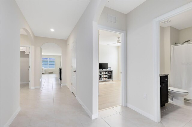 hallway with light tile patterned floors