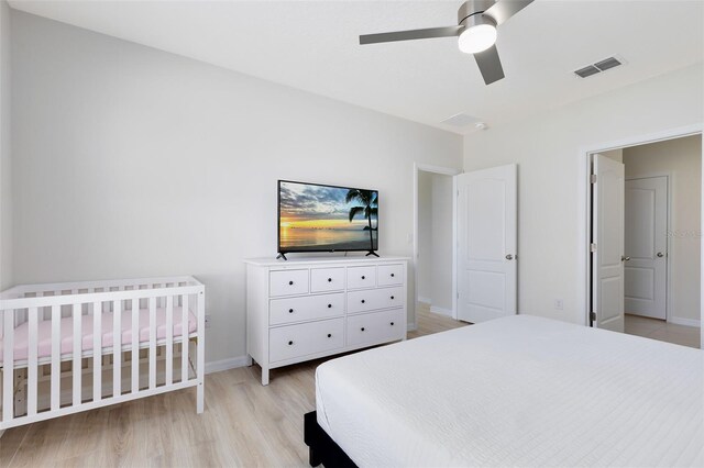 bedroom with light wood-type flooring and ceiling fan