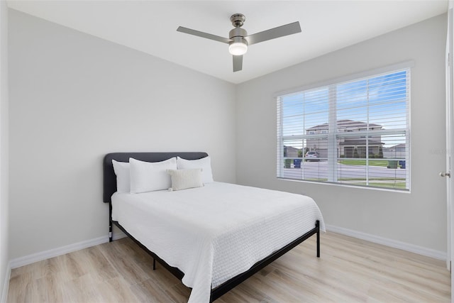 bedroom with ceiling fan and light hardwood / wood-style flooring