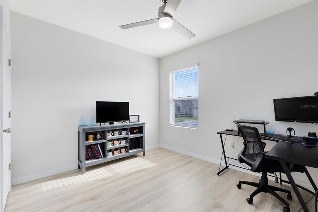 office with ceiling fan and light hardwood / wood-style flooring