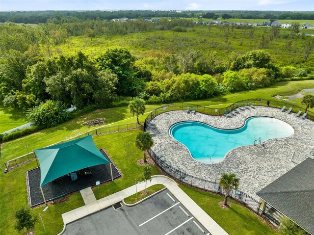 view of swimming pool featuring a yard and a patio area