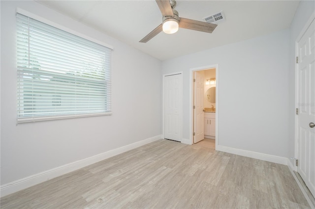 unfurnished bedroom with a closet, visible vents, light wood-style floors, connected bathroom, and baseboards