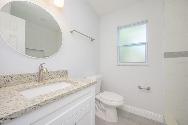 full bathroom featuring vanity, toilet, and baseboards