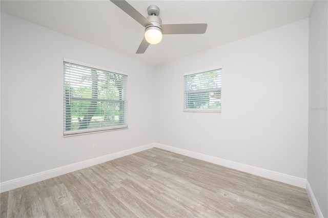 empty room with light wood-type flooring, ceiling fan, and baseboards