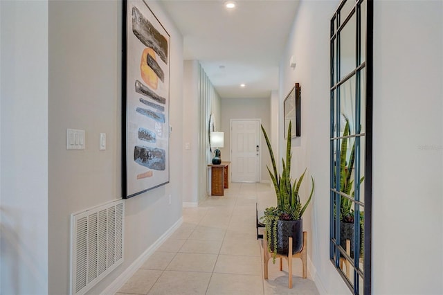 hall with light tile patterned floors