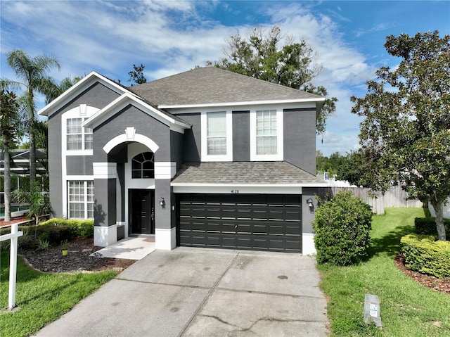 view of front property with a front yard and a garage