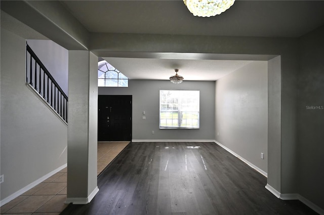 foyer entrance with a notable chandelier and wood-type flooring