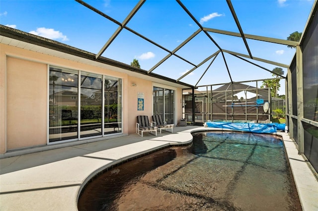 view of pool with a lanai and a patio