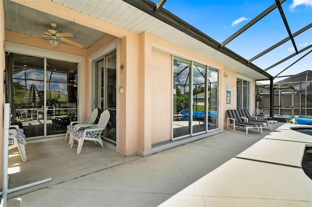 view of patio with a lanai and ceiling fan