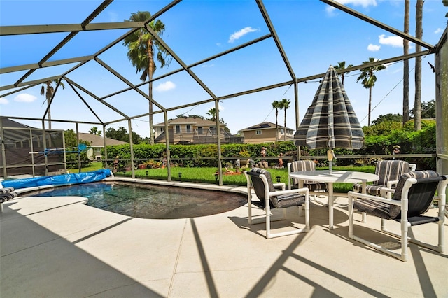 view of patio / terrace with a covered pool and glass enclosure