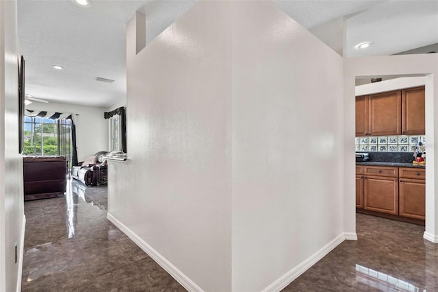 hall featuring dark tile patterned flooring