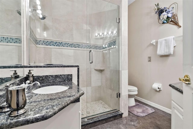 bathroom with a shower with shower door, vanity, and toilet