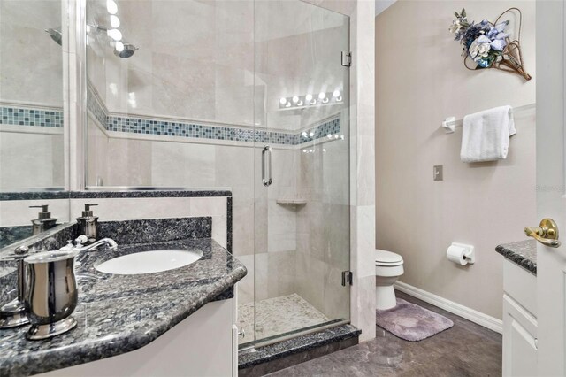2907 Sunset Lakes Blvd, Kissimmee, FL 34747 - bathroom featuring vanity, a shower stall, baseboards, and toilet