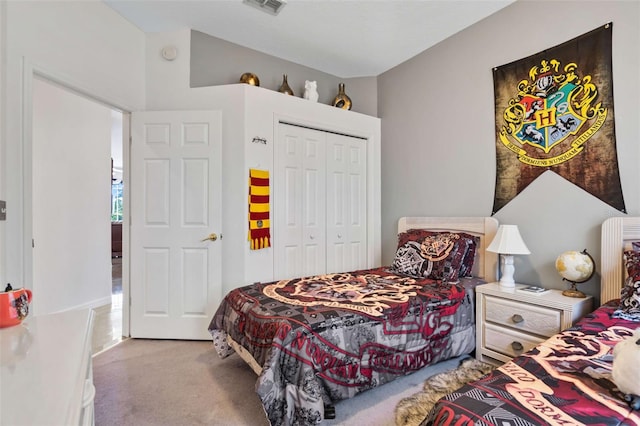 bedroom with light carpet and a closet