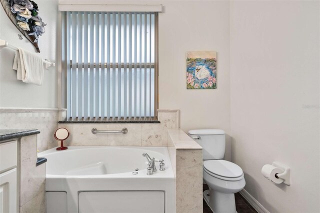 2907 Sunset Lakes Blvd, Kissimmee, FL 34747 - bathroom featuring a bath, toilet, and vanity