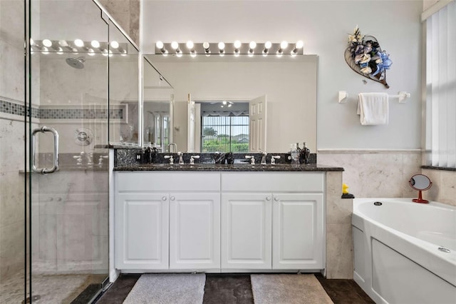 bathroom with vanity, plus walk in shower, and tile walls