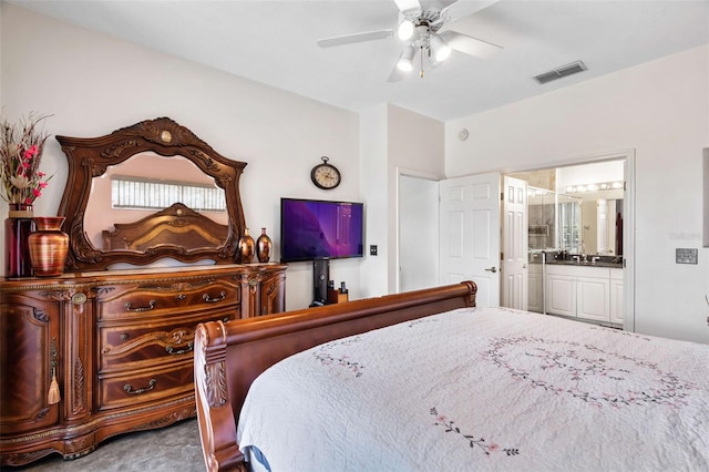 bedroom with carpet, ceiling fan, and ensuite bathroom