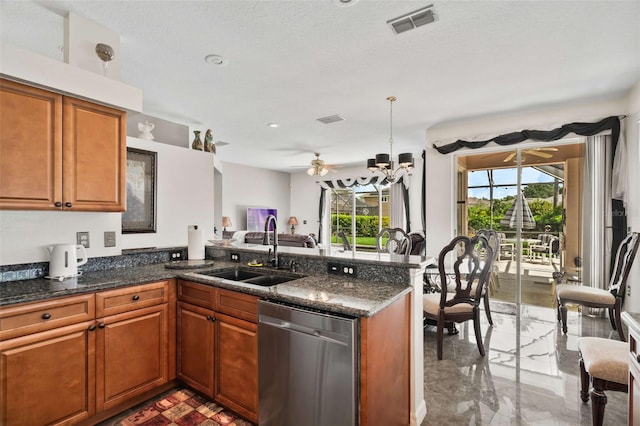 kitchen featuring hanging light fixtures, kitchen peninsula, dishwasher, a textured ceiling, and sink