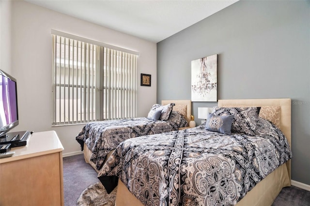 bedroom featuring dark colored carpet