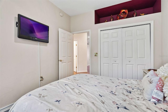 bedroom featuring a baseboard radiator and a closet