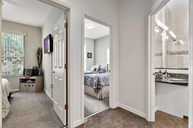 2907 Sunset Lakes Blvd, Kissimmee, FL 34747 - hallway featuring baseboards and a sink