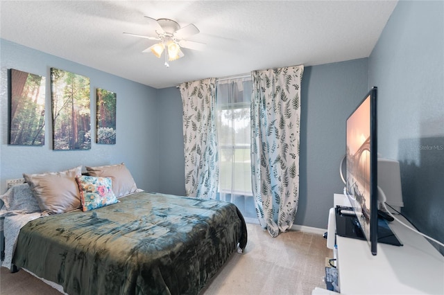 carpeted bedroom with a textured ceiling and ceiling fan