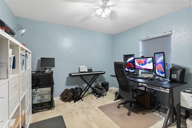 office area featuring ceiling fan, light colored carpet, and a textured ceiling