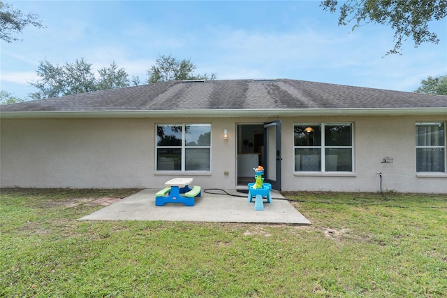 rear view of house featuring a patio area and a yard