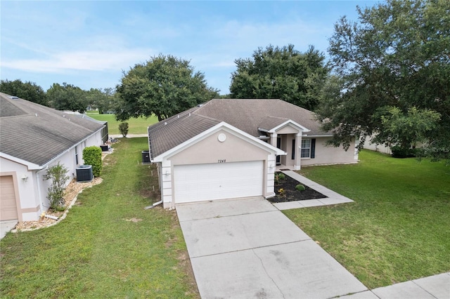 ranch-style house featuring a front yard, a garage, and central AC unit