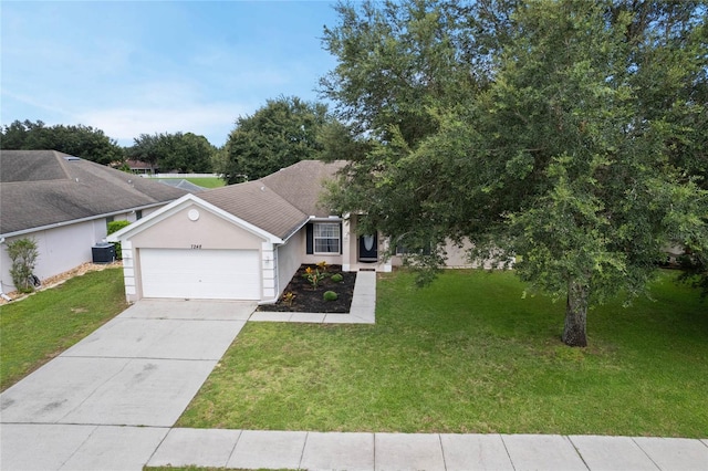 view of front of property featuring a garage and a front lawn