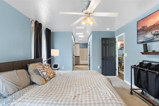 carpeted bedroom featuring ceiling fan and a textured ceiling