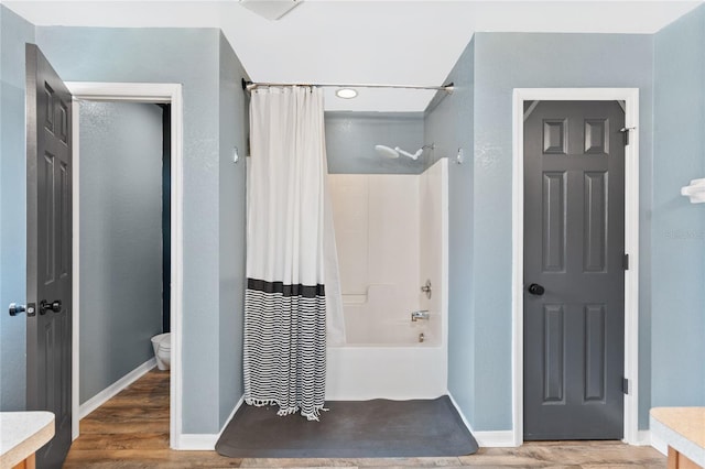 bathroom featuring shower / bath combination with curtain, toilet, and wood-type flooring