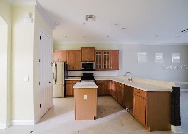 kitchen with ornamental molding, stainless steel appliances, kitchen peninsula, and sink