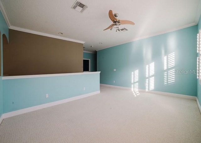 carpeted empty room with ornamental molding and ceiling fan