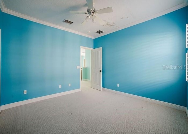 carpeted spare room with crown molding and ceiling fan