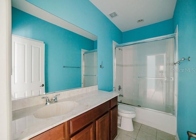 full bathroom with tile patterned flooring, vanity, toilet, and combined bath / shower with glass door