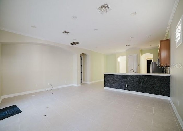 8162 Via Bella Notte, Orlando, FL 32836 - unfurnished living room with arched walkways, light tile patterned flooring, and ornamental molding