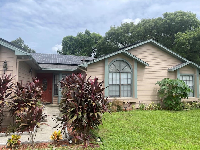 bungalow-style home with a front lawn