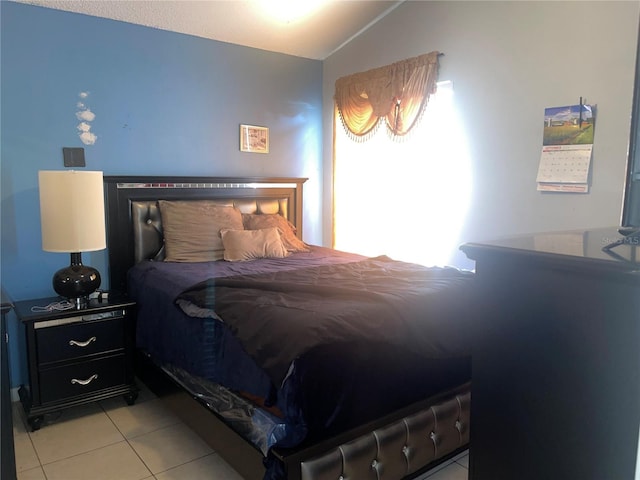 tiled bedroom with vaulted ceiling