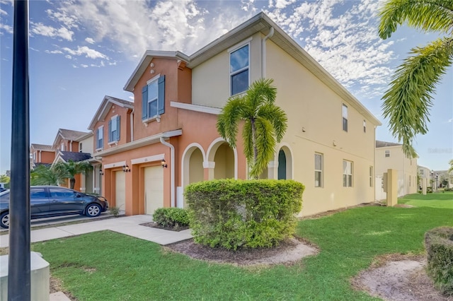 view of front of property with a garage and a front lawn